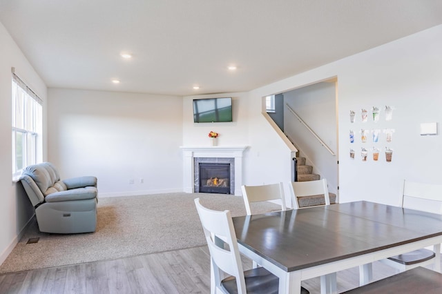 830 Foxglove Ter, Waconia, MN 55387 - dining room featuring a tiled fireplace, stairs, wood finished floors, recessed lighting, and baseboards