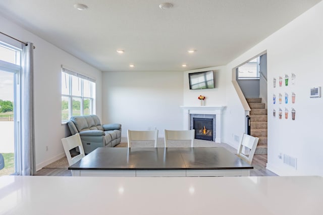 830 Foxglove Ter, Waconia, MN 55387 - dining area featuring a high end fireplace, baseboards, recessed lighting, and light wood finished floors