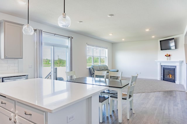 830 Foxglove Ter, Waconia, MN 55387 - kitchen featuring open floor plan, light wood finished floors, light countertops, recessed lighting, and decorative light fixtures