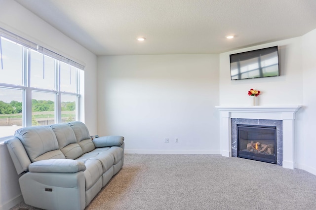 830 Foxglove Ter, Waconia, MN 55387 - living area with carpet, a tiled fireplace, baseboards, recessed lighting, and a textured ceiling