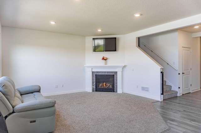 830 Foxglove Ter, Waconia, MN 55387 - living area with stairway, a fireplace, baseboards, recessed lighting, and a textured ceiling