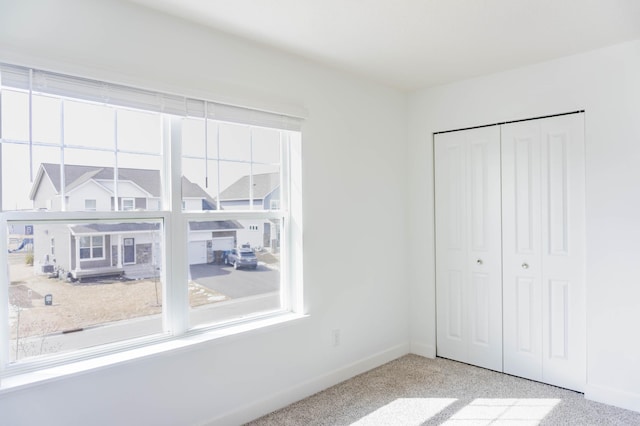 830 Foxglove Ter, Waconia, MN 55387 - unfurnished bedroom with baseboards, a closet, and carpet floors