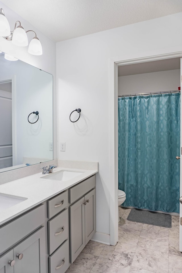 830 Foxglove Ter, Waconia, MN 55387 - bathroom featuring toilet, double vanity, a shower with curtain, and a textured ceiling