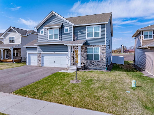 830 Foxglove Ter, Waconia, MN 55387 - view of front of home with stone siding, a garage, driveway, and a front lawn