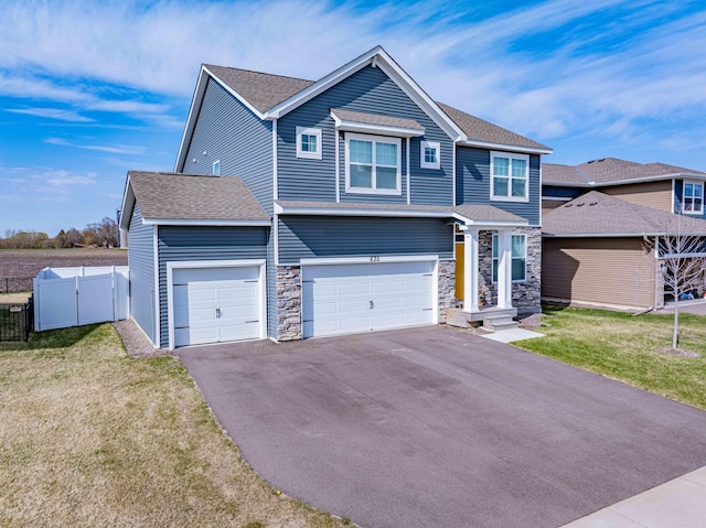 830 Foxglove Ter, Waconia, MN 55387 - view of front of home with asphalt driveway, stone siding, a shingled roof, and a garage