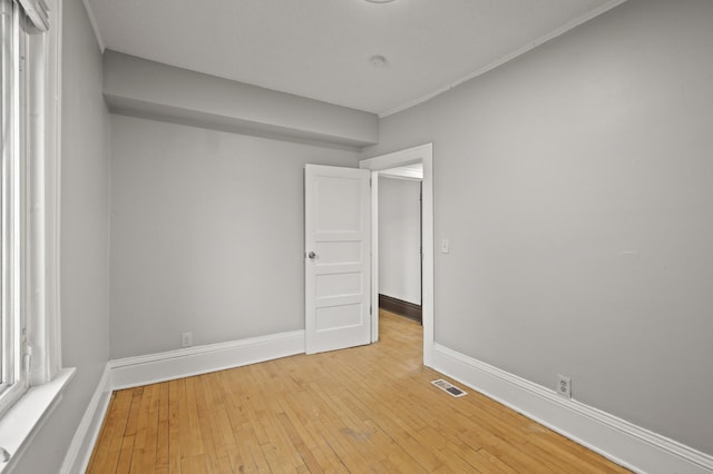 3400 Elliot Ave S, Minneapolis, MN 55407 - empty room with light wood-style floors, baseboards, and crown molding