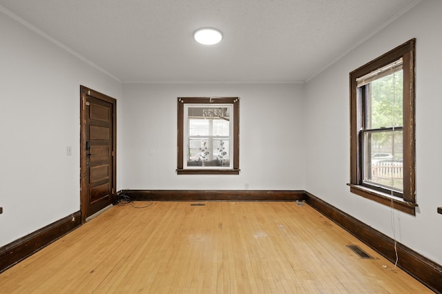 3400 Elliot Ave S, Minneapolis, MN 55407 - spare room featuring wood-type flooring, crown molding, and baseboards