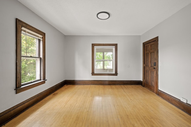 3400 Elliot Ave S, Minneapolis, MN 55407 - empty room featuring healthy amount of natural light, light wood-style floors, and baseboards