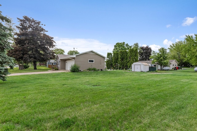 72 7th St, Cochrane, WI 54622 - view of green lawn featuring a shed, driveway, and an attached garage