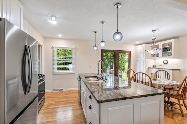 72 7th St, Cochrane, WI 54622 - kitchen featuring stainless steel appliances, plenty of natural light, light wood-type flooring, a textured ceiling, and recessed lighting