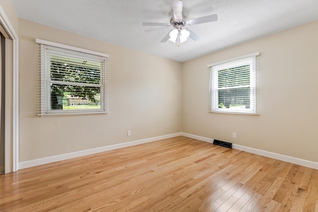 72 7th St, Cochrane, WI 54622 - spare room with wood finished floors, ceiling fan, and a textured ceiling