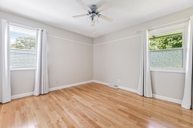 72 7th St, Cochrane, WI 54622 - empty room with plenty of natural light, light wood-style flooring, and ceiling fan
