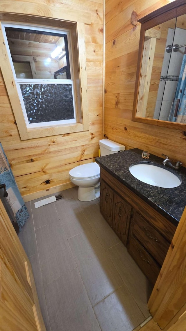 19146 Eaglewood Rd, Lynden Twp, MN 55320 - bathroom featuring toilet, vanity, and wooden walls