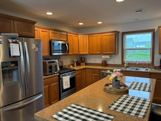 1108 11th Ave SE, Waseca, MN 56093 - kitchen with stainless steel appliances, a sink, brown cabinets, recessed lighting, and light countertops