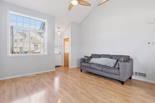 5995 Wedgewood Ln N Unit 84, Plymouth, MN 55446 - living area with light wood-type flooring, healthy amount of natural light, high vaulted ceiling, and baseboards