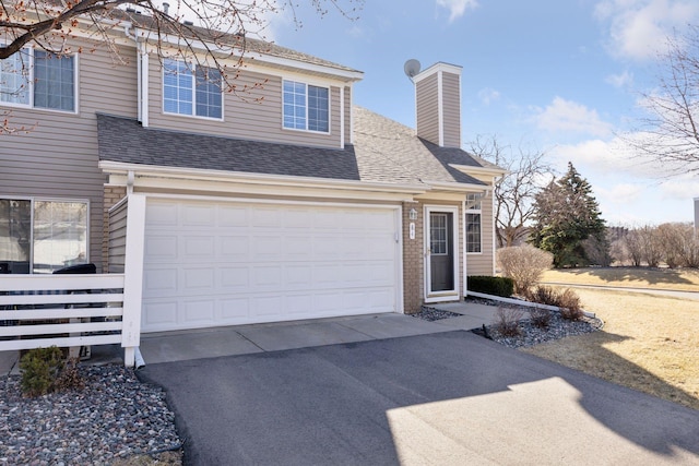 5995 Wedgewood Ln N Unit 84, Plymouth, MN 55446 - traditional-style house featuring driveway, a chimney, a shingled roof, and brick siding