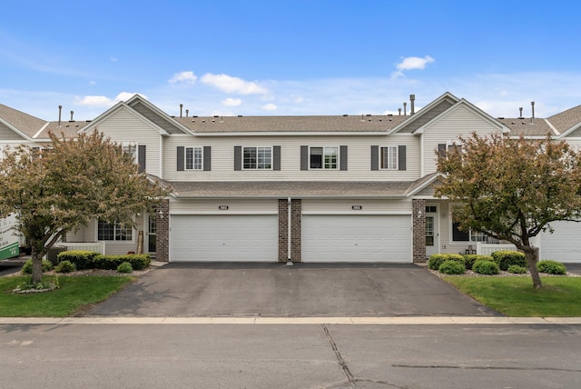 803 Willow Glen Ct, Buffalo, MN 55313 - townhome / multi-family property with driveway, brick siding, a garage, and a shingled roof