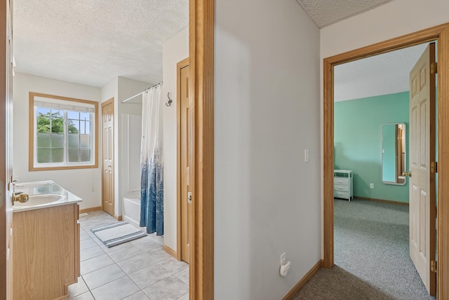 803 Willow Glen Ct, Buffalo, MN 55313 - bathroom with a textured ceiling, vanity, shower / bathtub combination with curtain, and tile patterned floors