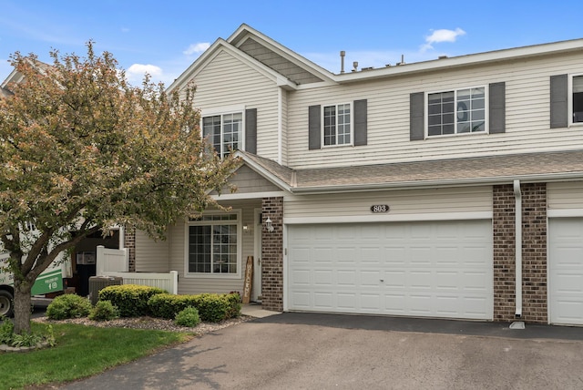 803 Willow Glen Ct, Buffalo, MN 55313 - townhome / multi-family property featuring brick siding, driveway, and an attached garage