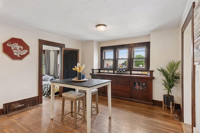 1104 21st Ave SE, Minneapolis, MN 55414 - dining room featuring wood finished floors and ornamental molding