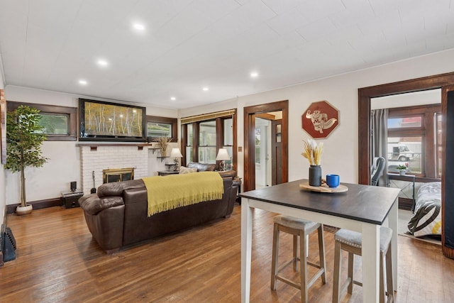 1104 21st Ave SE, Minneapolis, MN 55414 - living area with hardwood / wood-style flooring, recessed lighting, and a brick fireplace