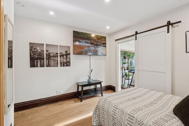 1104 21st Ave SE, Minneapolis, MN 55414 - bedroom with light wood-style floors, a barn door, and recessed lighting