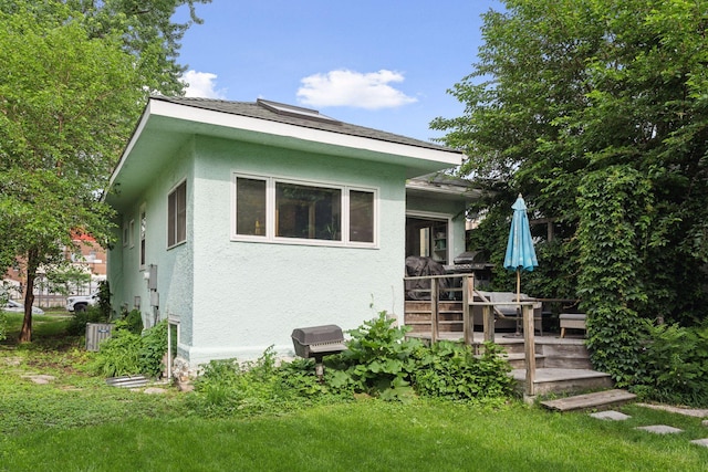 1104 21st Ave SE, Minneapolis, MN 55414 - rear view of house with stucco siding and a wooden deck