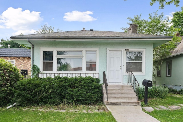 1104 21st Ave SE, Minneapolis, MN 55414 - view of front of house with stucco siding and a chimney