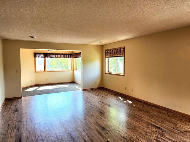 520 5th St SW Unit 318, Willmar, MN 56201 - unfurnished room featuring a textured ceiling, wood finished floors, and baseboards