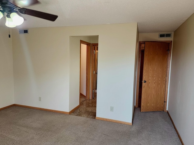 520 5th St SW Unit 318, Willmar, MN 56201 - empty room with ceiling fan, carpet, baseboards, and a textured ceiling