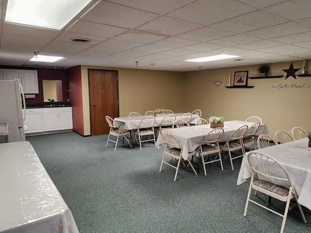 520 5th St SW Unit 318, Willmar, MN 56201 - dining space featuring dark carpet and a paneled ceiling