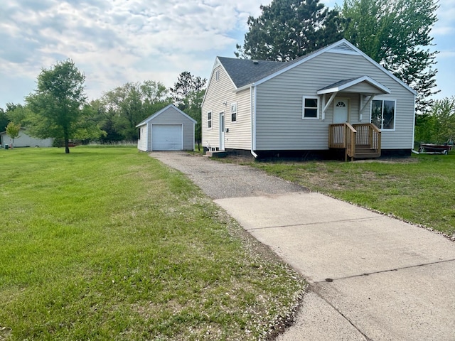 609 4th St NW, Wadena, MN 56482 - view of front of home featuring an outbuilding, asphalt driveway, a front lawn, a detached garage, and roof with shingles