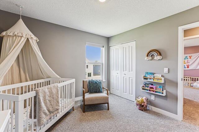 12719 Erskin St NE, Blaine, MN 55449 - carpeted bedroom with a closet, baseboards, a textured ceiling, and a nursery area