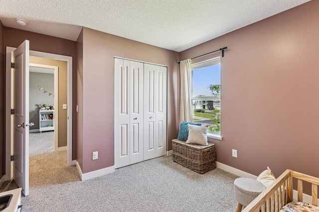 12719 Erskin St NE, Blaine, MN 55449 - bedroom with carpet floors, a closet, a textured ceiling, and baseboards