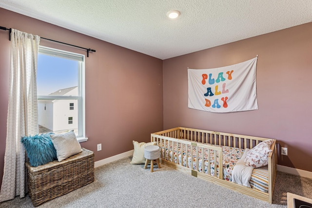12719 Erskin St NE, Blaine, MN 55449 - carpeted bedroom featuring a textured ceiling, baseboards, and a nursery area
