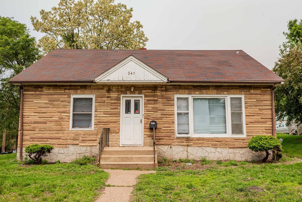 341 Maryland Ave E, Saint Paul, MN 55130 - view of front of home featuring a front lawn, stone siding, and roof with shingles