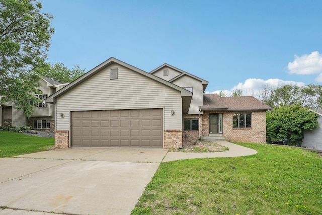 1504 Monarch St, Shakopee, MN 55379 - split level home featuring brick siding, a garage, driveway, and a front yard