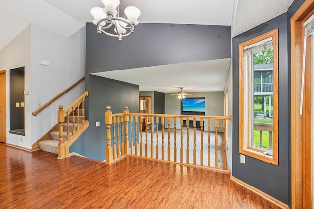 1504 Monarch St, Shakopee, MN 55379 - spare room with wood finished floors, a chandelier, lofted ceiling, and a ceiling fan