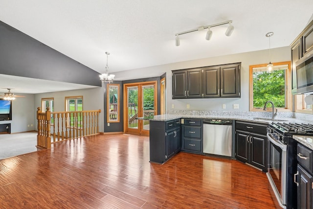 1504 Monarch St, Shakopee, MN 55379 - kitchen featuring stainless steel appliances, open floor plan, a peninsula, healthy amount of natural light, and vaulted ceiling