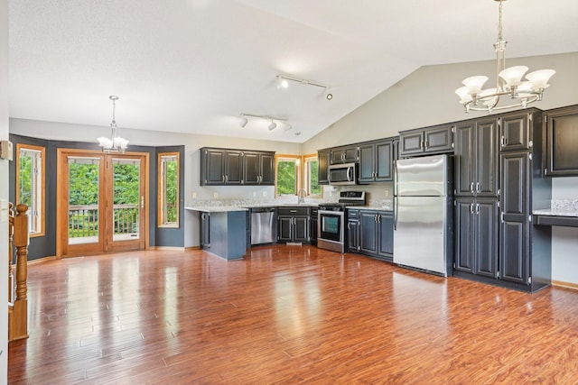 1504 Monarch St, Shakopee, MN 55379 - kitchen with stainless steel appliances, a chandelier, light countertops, decorative light fixtures, and wood finished floors