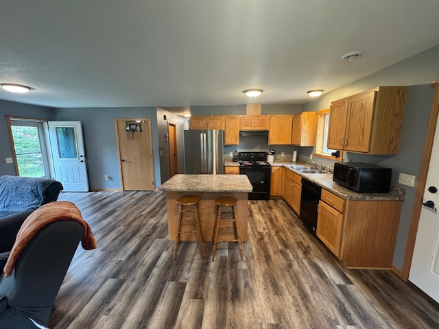 1101 Timbers Dr, Park Rapids, MN 56470 - kitchen with black appliances, open floor plan, a breakfast bar area, dark wood-type flooring, and a sink