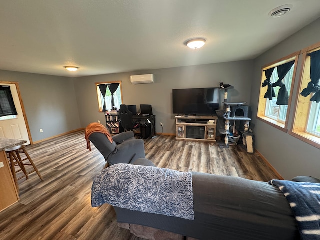 1101 Timbers Dr, Park Rapids, MN 56470 - living area with a wall mounted air conditioner, wood finished floors, and baseboards