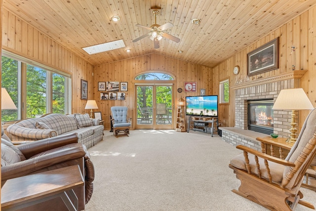 1115 Trappers Xing, Lino Lakes, MN 55038 - living room featuring healthy amount of natural light, lofted ceiling, wooden walls, a ceiling fan, and carpet flooring