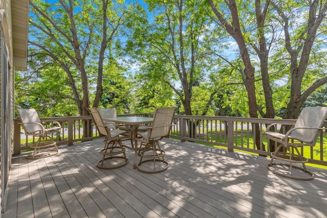 1115 Trappers Xing, Lino Lakes, MN 55038 - deck with outdoor dining area and view of wooded area