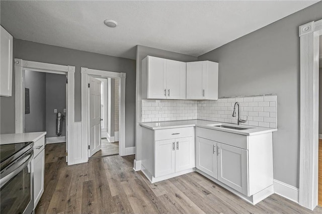 608 Beaumont St, Saint Paul, MN 55130 - kitchen featuring a sink, light countertops, and tasteful backsplash