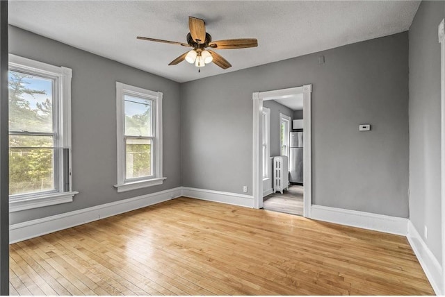 608 Beaumont St, Saint Paul, MN 55130 - spare room with hardwood / wood-style floors, plenty of natural light, and baseboards