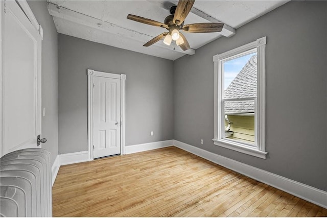 608 Beaumont St, Saint Paul, MN 55130 - unfurnished bedroom with radiator, baseboards, light wood-type flooring, and ceiling fan