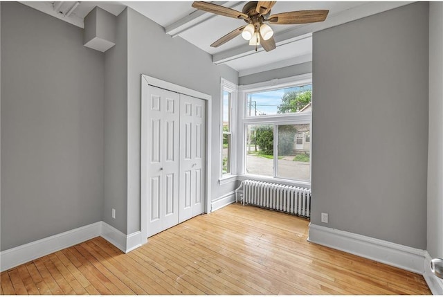 608 Beaumont St, Saint Paul, MN 55130 - unfurnished bedroom with radiator heating unit, baseboards, beam ceiling, hardwood / wood-style floors, and a closet