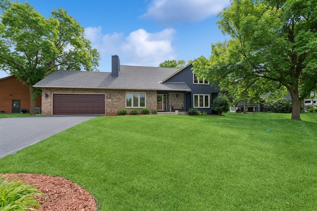 3720 Ximines Ln N, Plymouth, MN 55441 - view of front facade featuring a chimney, asphalt driveway, a front lawn, a garage, and brick siding