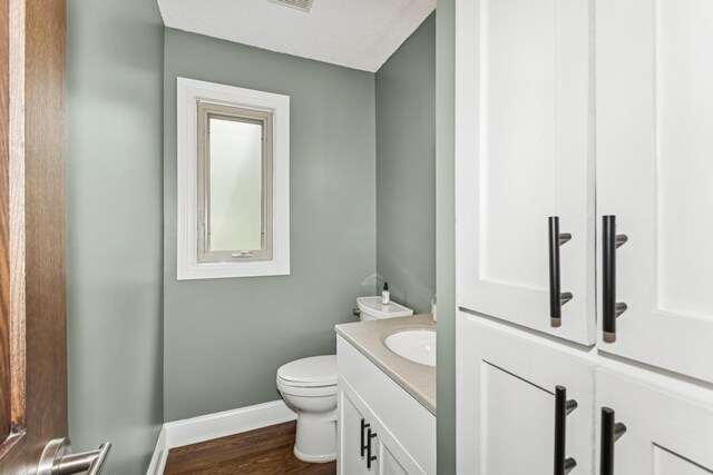 3720 Ximines Ln N, Plymouth, MN 55441 - half bathroom featuring vanity and wood finished floors